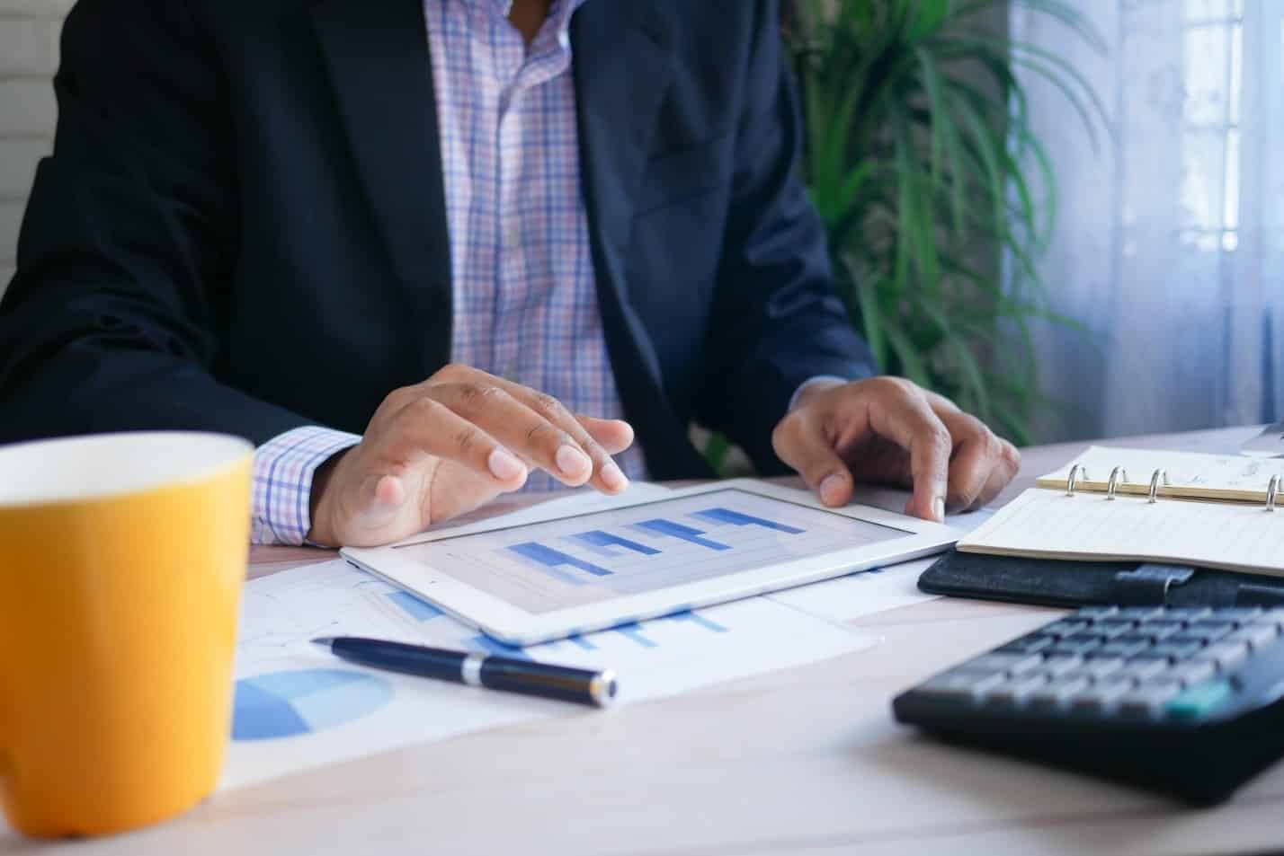 A professional analyzing data on a smart device